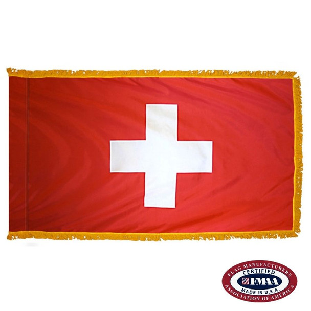 The indoor Swiss flag has 3 sides of gold fringe around a red field with a large white cross in the center. FMAA Certified Made in America seal.