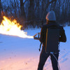 Woman Shooting XM42 flamethrower backpack