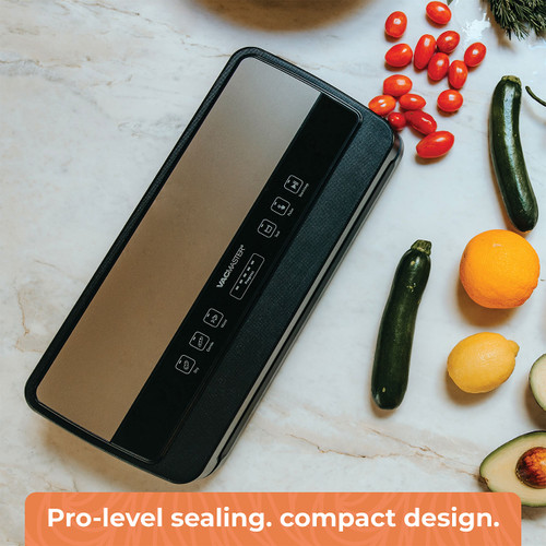 Overhead view of the VacMaster Sidekick Compact Vacuum Sealer displayed with fresh vegetables, highlighting its compact design and professional vacuum sealing capability. This compact vacuum sealing machine is built for everyday food preservation, allowing users to seal produce, meal prep ingredients, and stored food efficiently while saving space in the kitchen.