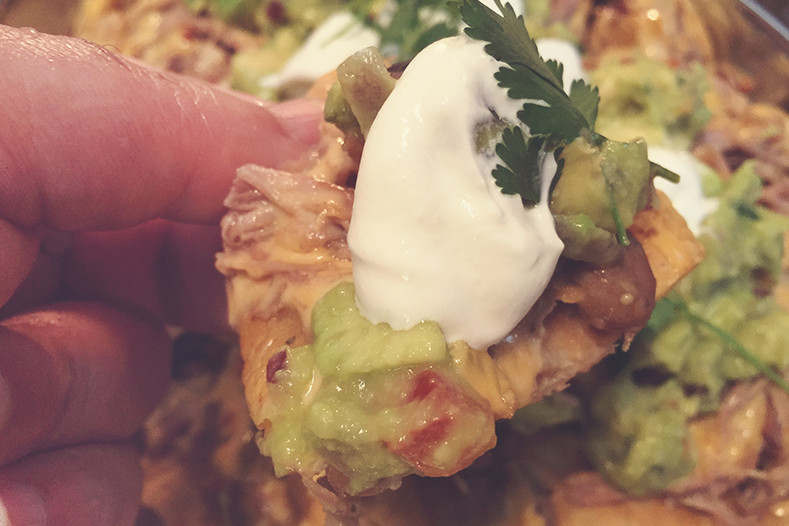 Pulled Pork Nachos with Sharp Cheddar, Pintos, and Guacamole 