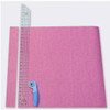 June Tailor Binding Buddy Ruler is featured in use. The ruler is laid onto a piece of pink fabric with a rotary cutter beside it, ready to make binding strips.