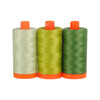 Three spools of Aurifil Dolomite 50wt Egyptian cotton thread in coordinating shades of green on a white background.