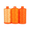 Three large spools of Aurifil Tuscany 50wt Egyptian cotton thread in gradient shades of orange on a white background.