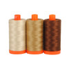 Three spools of Aurifil Florence Thread Collection in coordinating shades of brown.