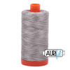 Large spool of Aurifil Silver Fox 50wt Egyptian cotton thread, variegated grey with Aurifil logo