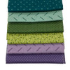 A stack of five Andover Jewelbox Spring fat quarters, showcasing an array of ditsy prints in shades of teal, mint green, olive, lime, and lavender.