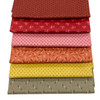 A stack of five Jewelbox Summer fat quarters by Andover Fabrics, featuring warm ditsy prints in shades of terracotta, red, pink, orange, and olive.