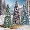Group of three no-sew fabric trees in prints from the Hill Shine collection, displayed outdoors in a snowy winter setting.