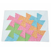 A beautifully crafted patchwork quilt featuring vibrant pinwheel patterns in shades of pink, orange, green, and blue, meticulously assembled using the June Tailor Twist 'n Stitch Pinwheel Block Ruler, displayed on a white background.