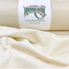 A roll of Hobbs Heirloom Premium Cotton Blend Wadding is displayed, with the brand's label prominently visible. The label describes the material as 80% cotton and 20% polyester, bonded and needle-punched. The wadding unrolls to reveal its fluffy, soft texture against a neutral backdrop, illustrating the quality material used for quilting projects. The focus on the label provides brand identification and product information for consumers seeking high-quality quilting materials.