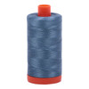 Large spool of Aurifil Blue Grey 50wt Egyptian cotton thread on orange spool.