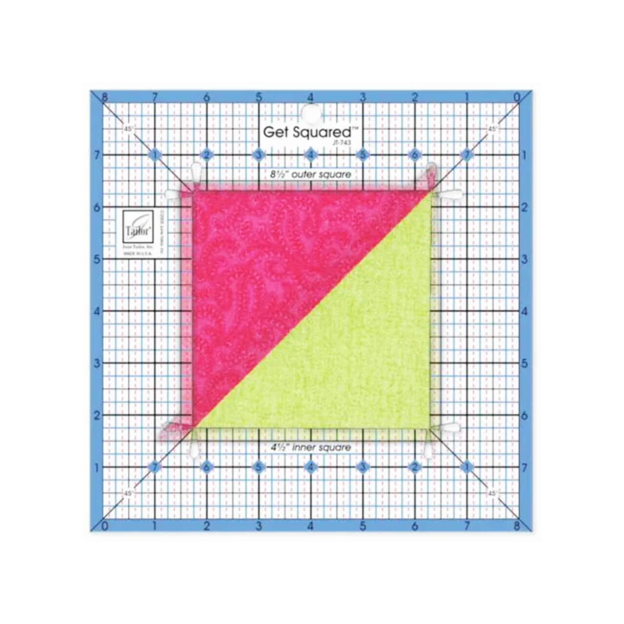 The Medium Get Squared Ruler by June Tailor in use, placed over a diagonally split pink and green fabric square, showing how it helps measure and trim quilt blocks to the precise size.