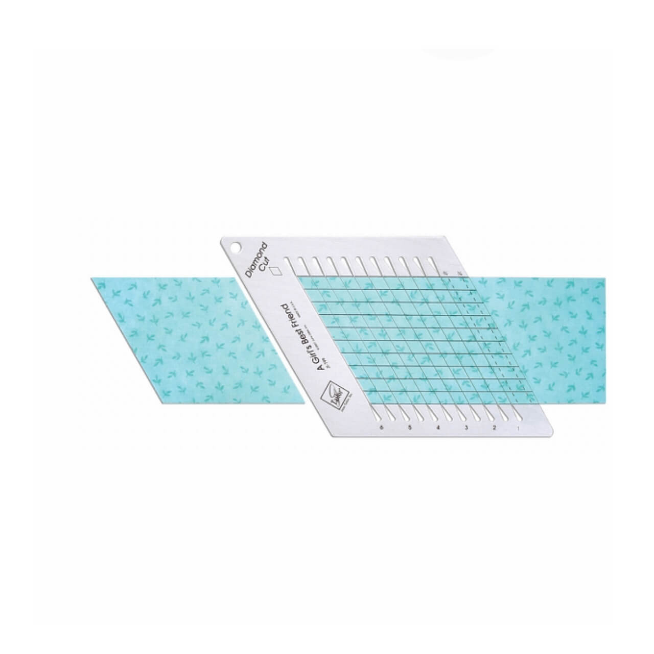The June Tailor Diamond Cut Ruler is positioned on a light blue fabric with a bird pattern, illustrating the tool's use for cutting diamond shapes in quilting projects.