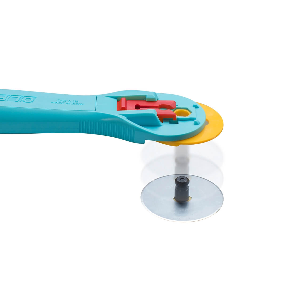 OLFA 45mm Quick-Change Rotary Cutter with its blade detached, demonstrating the quick-change mechanism, against a reflective surface.