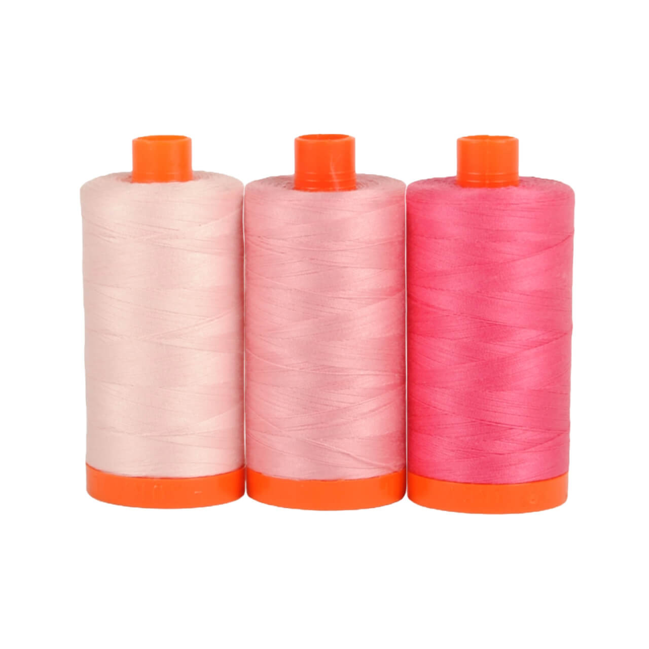 Three spools of Aurifil Sardinia 50wt Egyptian cotton thread in a gradient of pink colors on a white background.