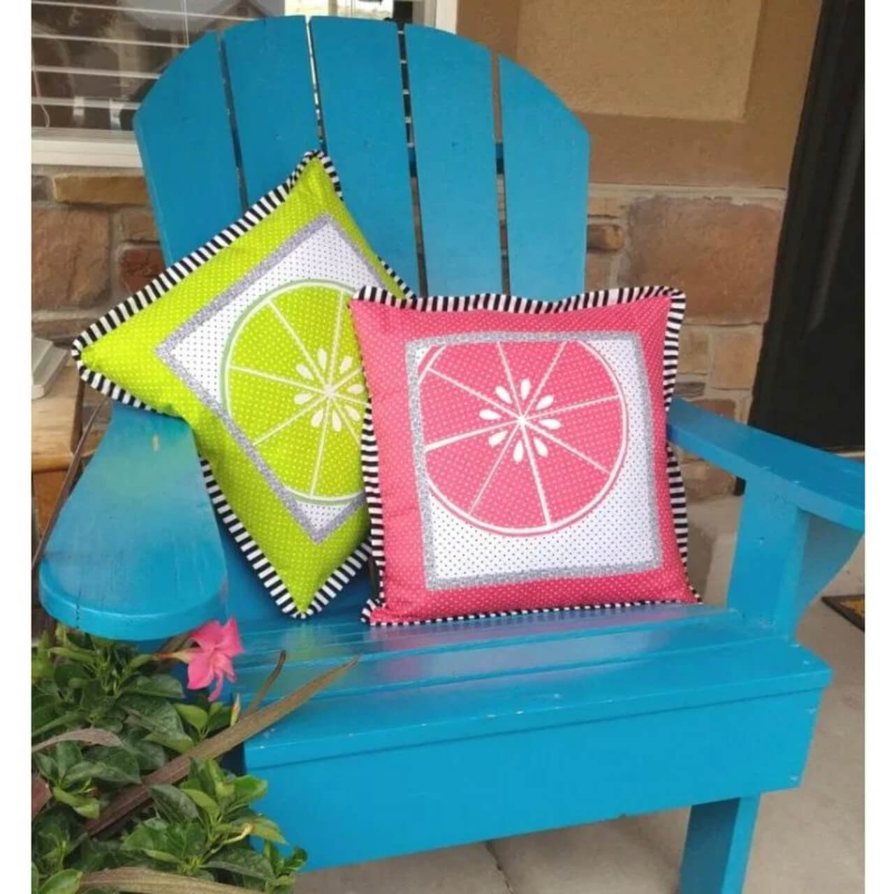 Two vibrant citrus-themed cushions showcased on a blue Adirondack chair, exemplifying the use of Therm-o-Web HeatnBond Feather Lite for creative home décor projects.