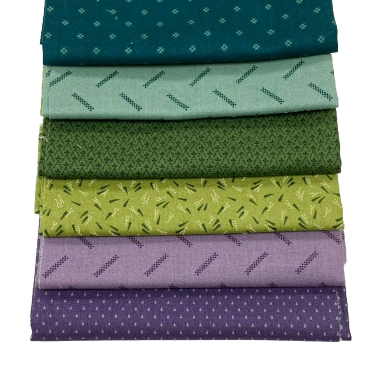 A stack of five Andover Jewelbox Spring fat quarters, showcasing an array of ditsy prints in shades of teal, mint green, olive, lime, and lavender.