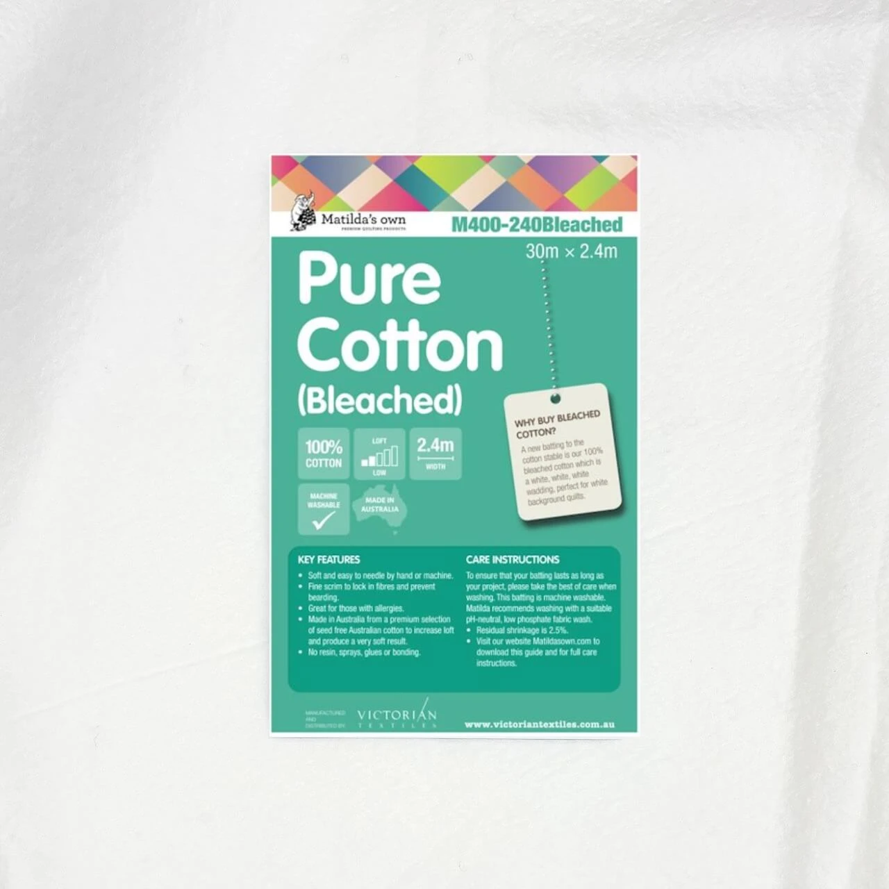 Matilda’s Own 100% Cotton Wadding product sheet displayed on the fabric, showing key benefits, care instructions, and label indicating a 30m x 2.4m roll.
