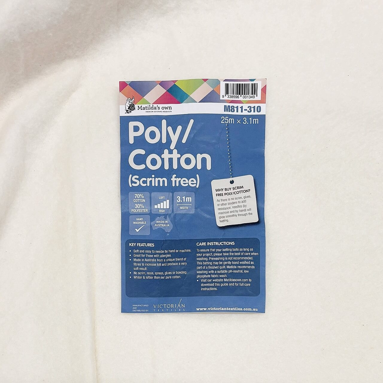 Close-up of Matilda’s Own Poly/Cotton (Scrim Free) product label on top of wadding, detailing key features, care instructions, and 70/30 fibre blend. Close-up of Matilda’s Own Poly/Cotton (Scrim Free) product label on top of wadding, detailing key features, care instructions, and 70/30 fibre blend.