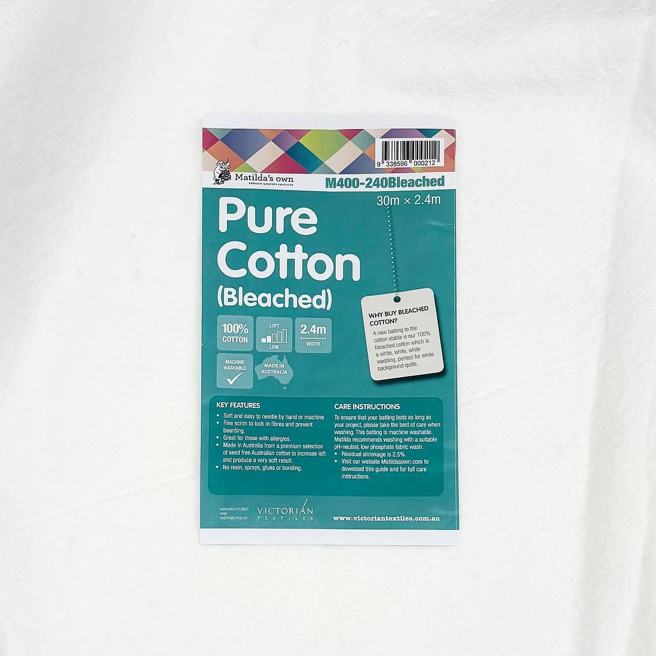 Matilda’s Own 100% White Cotton Wadding product sheet displayed on the fabric, showing key benefits, care instructions, and label indicating a 30m x 2.4m roll. Matilda’s Own 100% White Cotton Wadding product sheet displayed on the fabric, showing key benefits, care instructions, and label indicating a 30m x 2.4m roll.