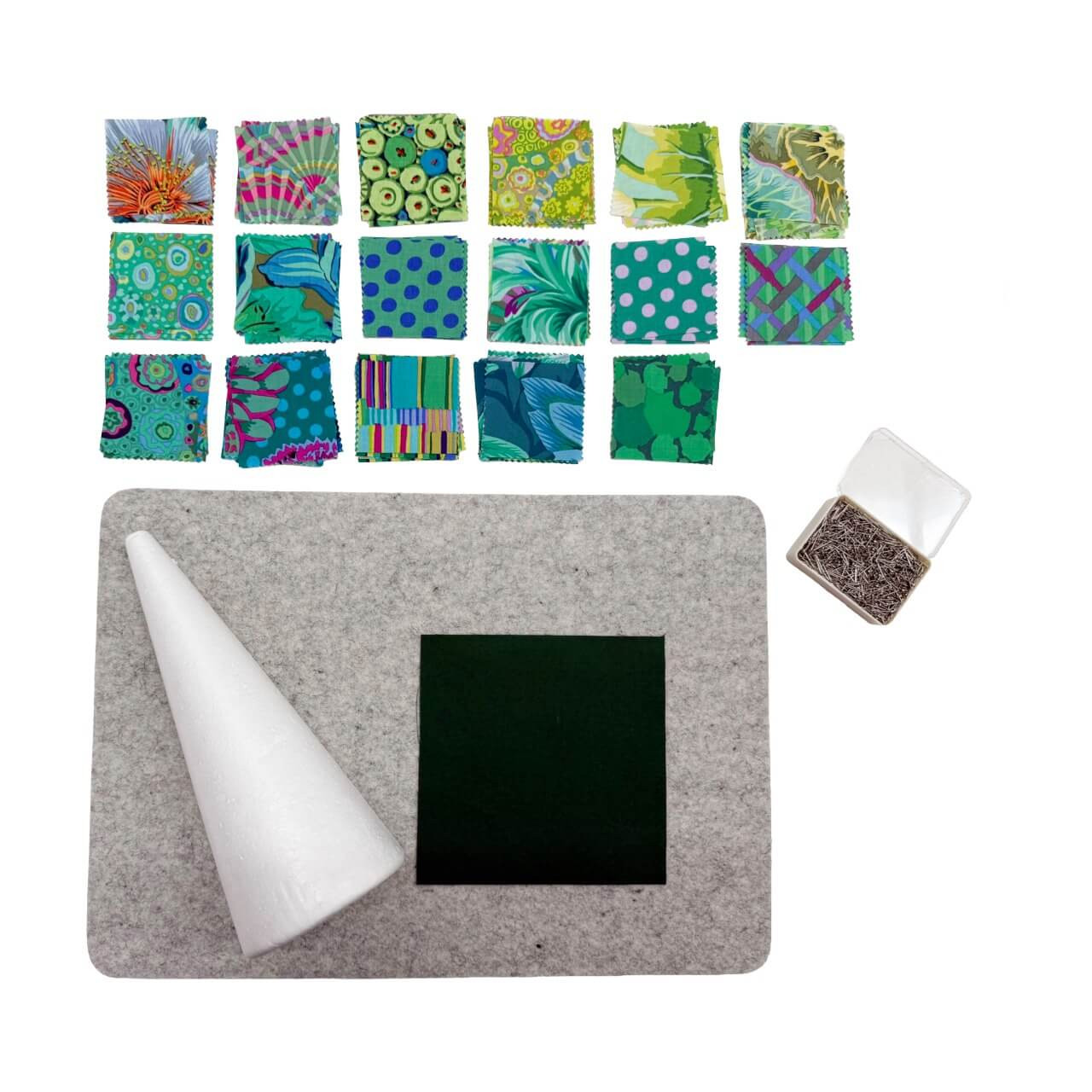 No Sew Tree craft kit contents including a polystyrene cone, pre-cut fabric squares in green and blue prints, and a box of pins.