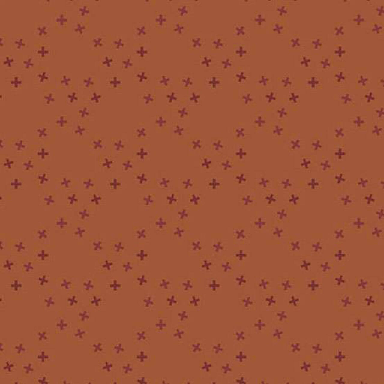 Andover Fabrics Moody Hues X Toss Rust quilting cotton with small burgundy cross motifs scattered across rust background