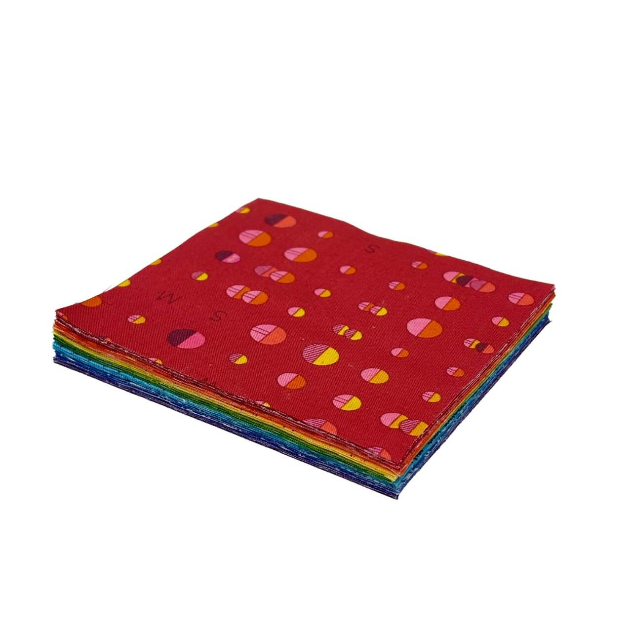 Rainbow Burst 5" Charm Squares stacked to show layered rainbow colours and bold Andover Fabrics prints.