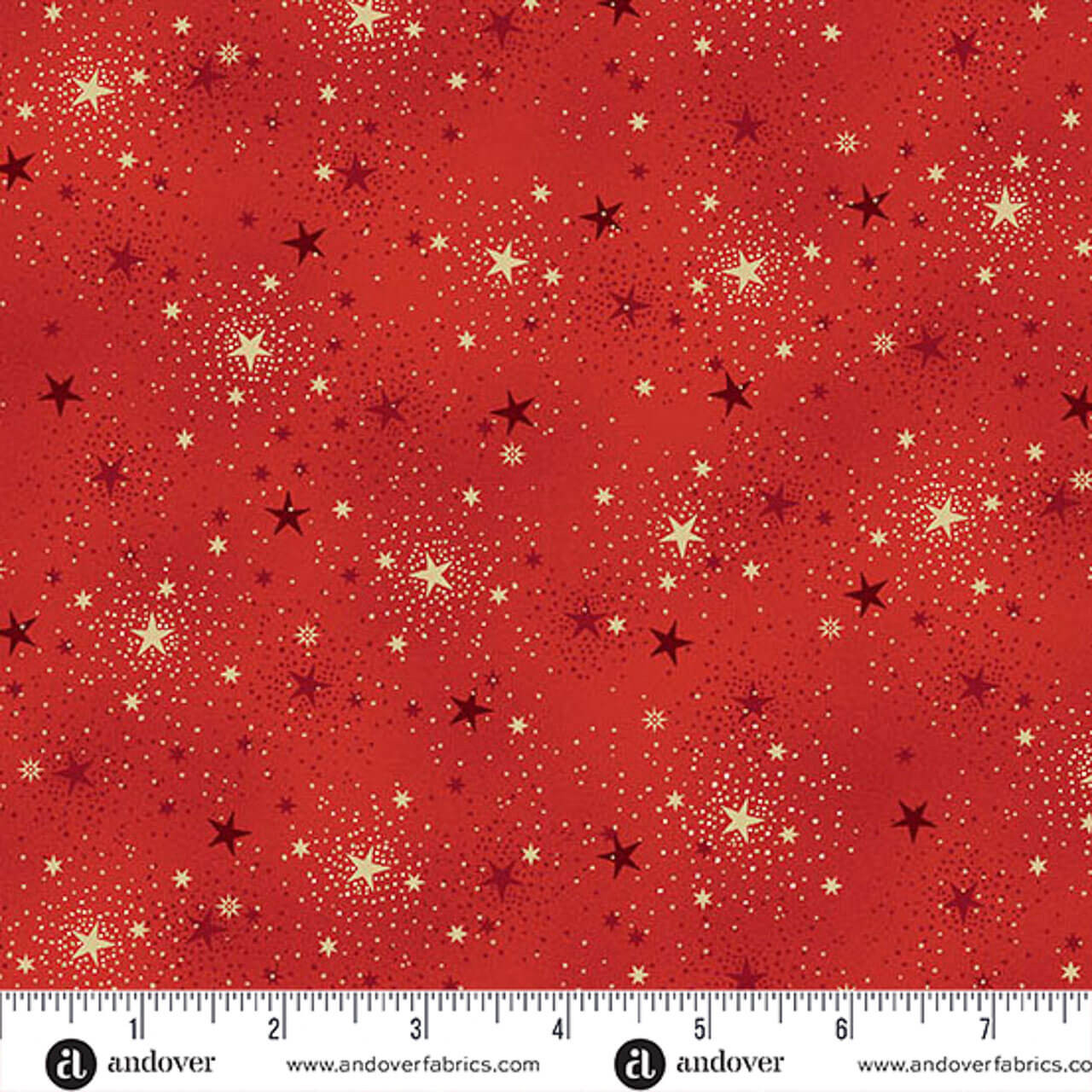 Makower UK Adorn Collection Sparkle in Red metallic quilting fabric shown with ruler for scale, featuring crimson red background, gold stars and delicate dotted constellations.