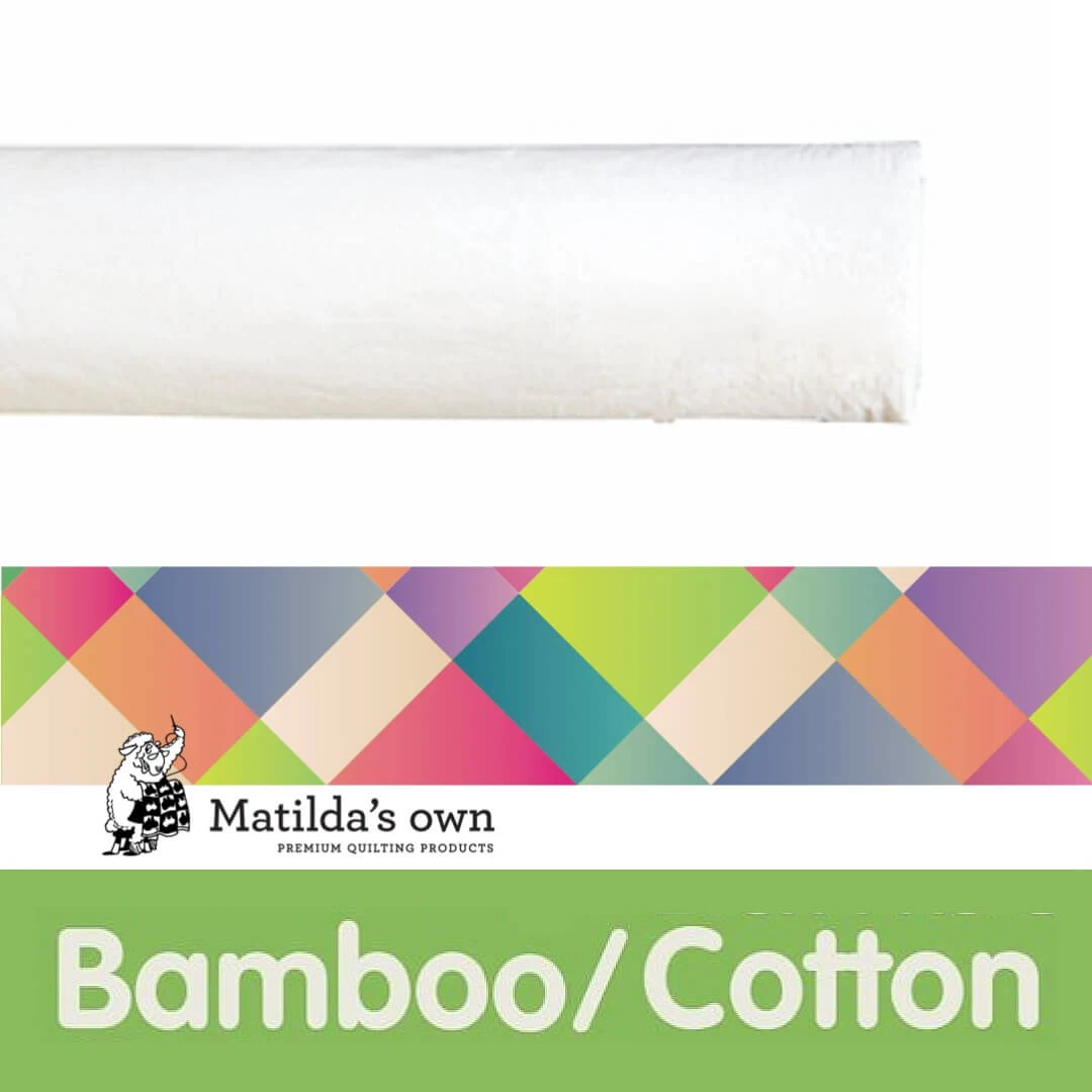 A roll of Matilda's Own Bamboo Quilt / Cotton Wadding, a premium-quality, natural quilt batting. The wadding appears soft and white, rolled neatly. Below the roll, there is a colourful, geometric-patterned banner featuring the Matilda's Own logo, which includes a small illustration of a sheep holding a quilt. The bottom section has a bright green background with the word "Bamboo" in bold white letters, emphasising the product’s natural fibre composition.
