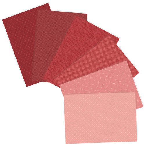 Six Andover Fabrics fat quarters in shades of red and pink with various patterns from the Tonal Ditsy Rouge collection.