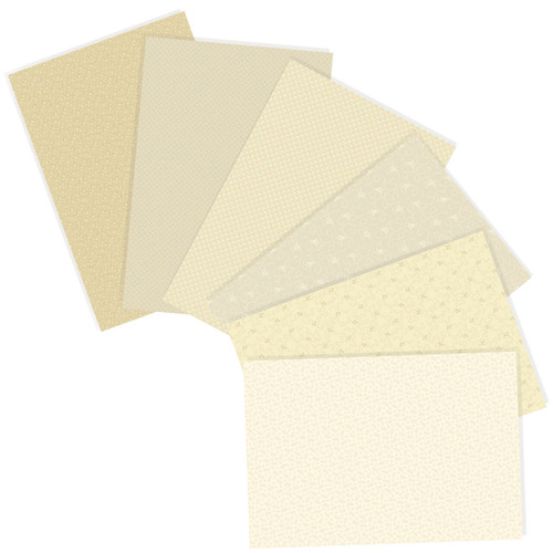 A collection of six cream-colored Andover Fabrics fat quarters from the Tonal Ditsy Creme Fraiche collection, displaying various subtle patterns.