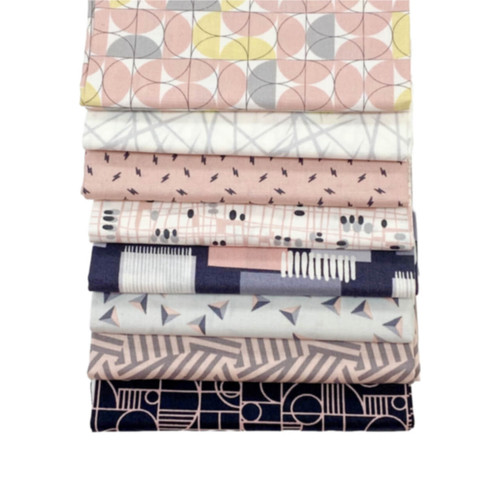 The image shows the 6 Shell Pink cascading fabric squares with geometric patterns in black, grey and pale pink. Bold shapes contrast with subtle designs, presenting a textured and varied assortment from the Rancho Relaxo series.