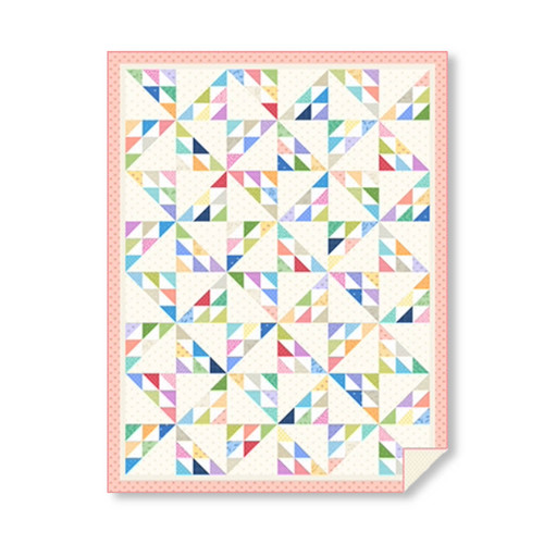 Completed Plain and Simple quilt showcasing soft ditsy floral prints in a geometric patchwork design, finished with a pink border.