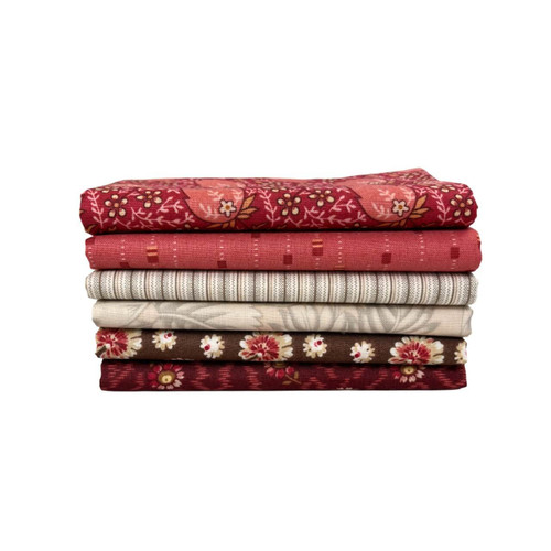 Rouge Mix Fat Quarter Bundle by Laundry Basket Quilts, featuring six red, brown, and cream floral and tonal prints stacked neatly.