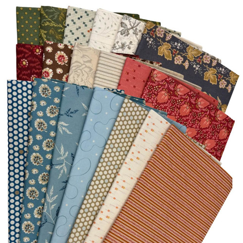 Fanned display of 20 different Laundry Basket Quilts fabric prints by Edyta Sitar, arranged in a semi-circle. The fabrics feature florals, stripes, dots, and vintage-style motifs in a coordinated palette of red, blue, green, cream, and gold tones.