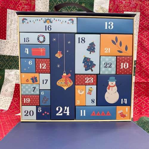 Open Quilter’s Advent Calendar showing 24 numbered drawers Open Quilter’s Advent Calendar showing 24 numbered drawers