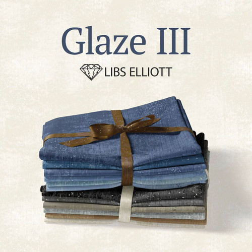Glaze III Fat Quarter Bundle by Libs Elliott showing 26 folded textured fabrics in blue, grey, beige, and brown tones tied with ribbon.