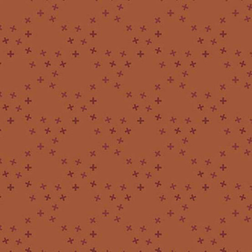 Andover Fabrics Moody Hues X Toss Rust quilting cotton with small burgundy cross motifs scattered across rust background