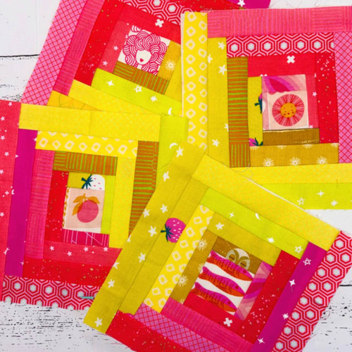 Manx Log Cabin quilt blocks showing folded fabric strips and textured hand stitching inspired by traditional Isle of Man patchwork.
