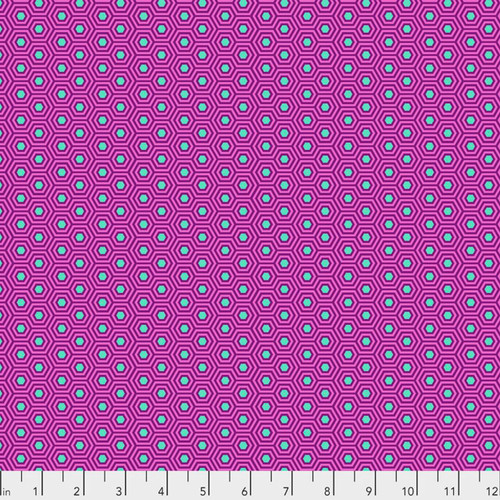 Hexy in Thistle by Tula Pink for FreeSpirit Fabrics featuring small aqua hexagons with layered purple outlines on a vibrant pink background from the True Colors collection.