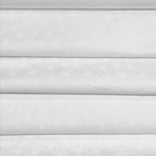 Fabric Freedom White Poppies white-on-white cotton quilting fabric folded to showcase the stylised poppy floral design.