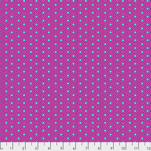 Hexy in Thistle by Tula Pink for FreeSpirit Fabrics featuring small aqua hexagons with layered purple outlines on a vibrant pink background from the True Colors collection.