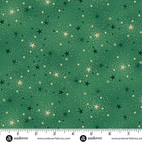 Makower UK Adorn Collection Sparkle in Green metallic quilting fabric shown with ruler for scale, featuring evergreen background, gold stars and delicate dotted constellations.