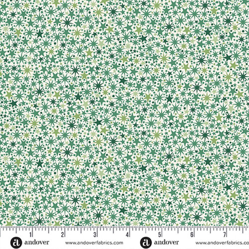 Makower UK The Nutcracker Collection Twinkle Green on Cream fabric with green stars and starbursts on cream, shown with a ruler for scale.
