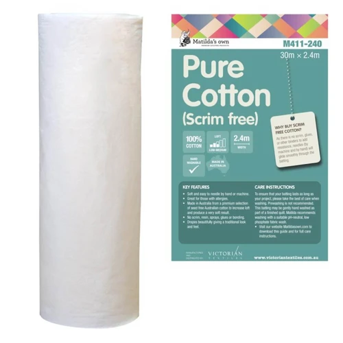 Roll of Matilda's Own 100% Cotton Quilt Wadding Scrim Free with its green product label beside. The label highlights key features, including "100% Cotton," "Machine Washable," and "2.4m Width." It also states that the wadding is "Made in Australia" and provides a low loft for a traditional quilting finish. A section on the label explains the benefits of pure cotton wadding, mentioning its breathability, softness, and suitability for heirloom quilting. Care instructions and key product details are listed at the bottom, along with the Victorian Textiles logo and website information.
