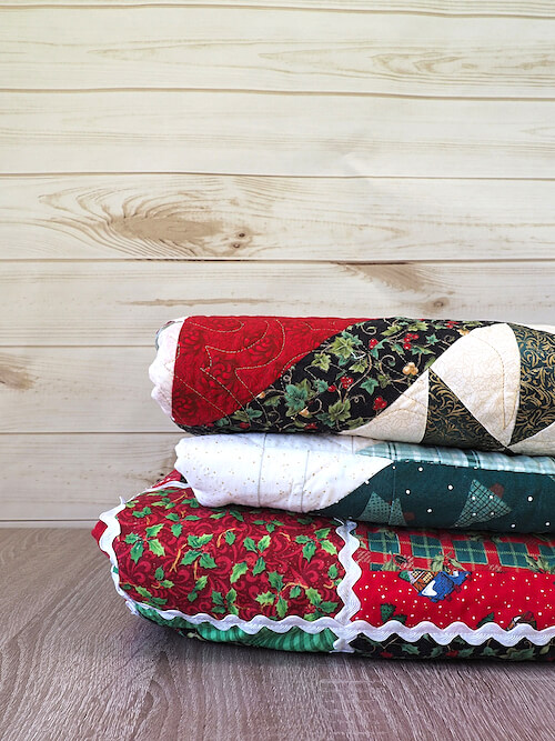 Stack of Christmas Quilts - Christmas Fabric Prints