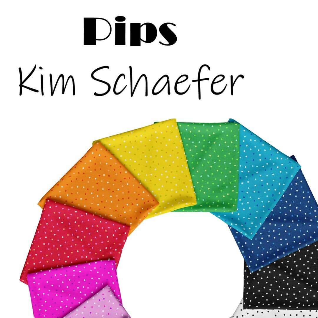 Image showing the Pips fabric collection by Kim Schaefer for Andover Fabrics, featuring 10 vibrant polka dot fabrics arranged in a semi-circle, showcasing a rainbow of colors including red, orange, yellow, green, blue, and black.