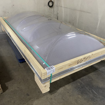 Kingspan KT12 triarch dome skylight crated in a wooden shipping frame, warehouse photo