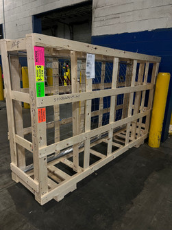 Crated safety screens with fragile and high-claim shipping labels in a warehouse