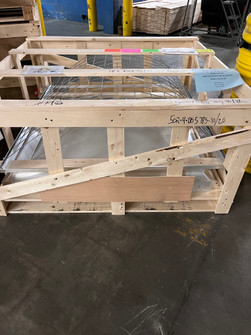 Velux shrink-out smoke vent dome and wire safety cage packed together in a wood shipping crate with fragile labels